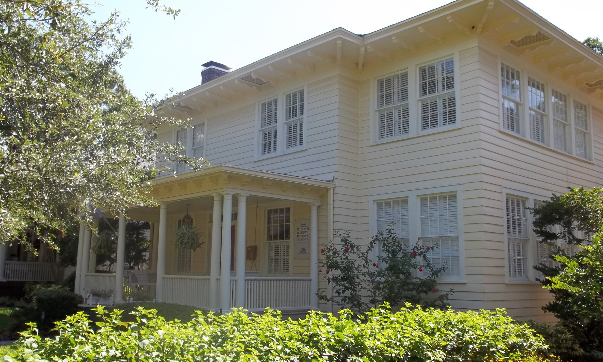 A two-story residential home in the Hyde Park historic district of Tampa, with a front porch and mature landscaping